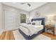 Charming bedroom with a blue upholstered bed frame, ceiling fan, and hardwood floors at 549 N Ogden St, Denver, CO 80218