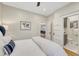 Bright bedroom featuring a bed, ensuite bathroom, hardwood floors, and neutral decor at 549 N Ogden St, Denver, CO 80218