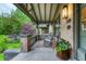 Relaxing front porch with rocking chairs, potted flowers, and intricate woodwork at 549 N Ogden St, Denver, CO 80218