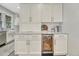 Kitchen features white cabinets, a built-in wine fridge, and marble countertops at 549 N Ogden St, Denver, CO 80218