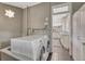 Laundry room with brick walls, large washing machine, and open doorway to bright, updated kitchen at 549 N Ogden St, Denver, CO 80218