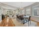 Open-concept living and dining area with hardwood floors, a fireplace, and stylish furnishings at 549 N Ogden St, Denver, CO 80218