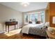 Charming bedroom with a sitting area in front of a bright window at 8903 Edgewood St, Highlands Ranch, CO 80130