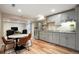 Basement kitchen featuring gray cabinets, stainless steel appliances, and new lighting at 8903 Edgewood St, Highlands Ranch, CO 80130