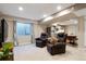 Cozy living room in basement featuring a tv and 2 recliner chairs at 8903 Edgewood St, Highlands Ranch, CO 80130