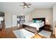 Spacious main bedroom featuring hardwood floors, a ceiling fan, and French doors to an upstairs living area at 8903 Edgewood St, Highlands Ranch, CO 80130