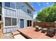 Charming backyard features a wood deck, lovely patio furniture, string lights, and privacy fence at 2854 N Lowell Blvd, Denver, CO 80211