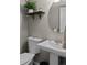 Bathroom with white vanity, toilet, and a decorative shelf with small plant at 2854 N Lowell Blvd, Denver, CO 80211