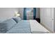 Bedroom with a plush blue bed and a large window with blue curtains at 2854 N Lowell Blvd, Denver, CO 80211