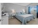 Bedroom with a plush blue bed, side tables, and a large window with blue curtains at 2854 N Lowell Blvd, Denver, CO 80211