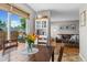 Bright dining area with hardwood table and chairs looking into the living room and out to the wooden patio at 2854 N Lowell Blvd, Denver, CO 80211