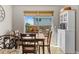 Cozy dining room features wood table set and a view of the backyard patio with outdoor seating at 2854 N Lowell Blvd, Denver, CO 80211