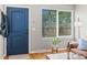 Welcoming entryway boasts beautiful blue door, hardwood floors, natural light, and a coat rack at 2854 N Lowell Blvd, Denver, CO 80211