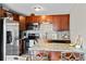 Kitchen with granite countertop island and dark wood cabinets featuring stainless steel appliances at 2854 N Lowell Blvd, Denver, CO 80211
