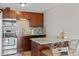 Kitchen with granite countertop island and dark wood cabinets featuring stainless steel appliances at 2854 N Lowell Blvd, Denver, CO 80211