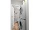 Laundry area featuring a stacked washer and dryer unit and a bathroom off to the left at 2854 N Lowell Blvd, Denver, CO 80211