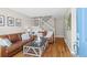 Inviting living room features hardwood floors, staircase with white railing, and comfortable seating at 2854 N Lowell Blvd, Denver, CO 80211