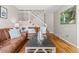 Inviting living room features hardwood floors, staircase with white railing, and comfortable seating at 2854 N Lowell Blvd, Denver, CO 80211