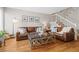 Inviting living room features hardwood floors, staircase with white railing, and comfortable seating at 2854 N Lowell Blvd, Denver, CO 80211