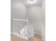 Carpeted stairwell with white railing leading to the upper floor of the home at 2854 N Lowell Blvd, Denver, CO 80211