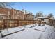 Large backyard featuring a wooden fence and snow covered grounds at 201 S Logan St, Denver, CO 80209