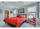 Bright bedroom featuring a large bed with red cover and light blue walls at 201 S Logan St, Denver, CO 80209