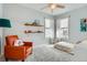 Cozy bedroom with armchair, wood shelves, and neutral decor at 201 S Logan St, Denver, CO 80209