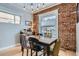 Cozy dining area featuring exposed brick, modern lighting, and hardwood floors at 201 S Logan St, Denver, CO 80209