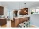 Stylish kitchen with granite countertops, dark wood cabinetry, and modern lighting fixtures at 201 S Logan St, Denver, CO 80209