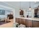 Open kitchen featuring breakfast bar, granite countertops, and seamlessly connected living space at 201 S Logan St, Denver, CO 80209