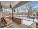 This covered front porch features two chairs and outdoor decoration at 201 S Logan St, Denver, CO 80209