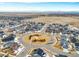 Aerial view of neighborhood with a central park at 9694 Truckee St, Commerce City, CO 80022