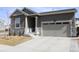Charming single-Gathering home with a gray exterior, stone accents, and a two-car garage at 9694 Truckee St, Commerce City, CO 80022