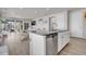 Open concept kitchen with island and stainless steel dishwasher at 9694 Truckee St, Commerce City, CO 80022