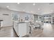 Open concept kitchen with a breakfast bar, modern appliances, stone accents, and beautiful hardwood floors at 9694 Truckee St, Commerce City, CO 80022