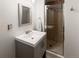 Bathroom features a single vanity, mirror, towel rack, and tiled shower with glass doors at 1120 N Clarkson St # 6, Denver, CO 80218