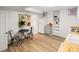 Bright kitchenette features wood floors, compact appliances, and a charming table and chairs at 1120 N Clarkson St # 6, Denver, CO 80218