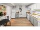 Well-lit kitchenette with wood floors, modern appliances, and a cozy dining area at 1120 N Clarkson St # 6, Denver, CO 80218