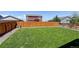 Fenced backyard featuring green lawn and privacy, perfect for outdoor activities and relaxation at 8861 Ventura St, Commerce City, CO 80022