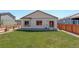 Large, well-maintained backyard with green grass, a fence, and ample space for outdoor activities at 8861 Ventura St, Commerce City, CO 80022