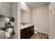 Bathroom with granite countertops, dark cabinets, and organized shelving for towels and baskets at 8861 Ventura St, Commerce City, CO 80022