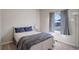 Relaxing bedroom with a comfortable bed, soft bedding, and a bright window with views of the neighborhood at 8861 Ventura St, Commerce City, CO 80022