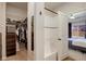 Walk in closet with custom shelving, ample storage, and a view to the ensuite bathroom at 8861 Ventura St, Commerce City, CO 80022