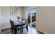 Dining table set for six with slider leading to fenced backyard at 8861 Ventura St, Commerce City, CO 80022