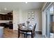 Dining area featuring a wood table set for four, modern art, and sliding glass door at 8861 Ventura St, Commerce City, CO 80022