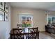 Dining table set for four with wall art in view of fenced backyard at 8861 Ventura St, Commerce City, CO 80022