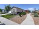 Charming single-story home featuring stone accents, mature landscaping, and a welcoming walkway at 8861 Ventura St, Commerce City, CO 80022