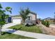 Well maintained front yard with mature tree and view of two-car garage at 8861 Ventura St, Commerce City, CO 80022