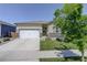 Inviting single-story home with a manicured lawn, well-kept landscaping, and a two-car garage at 8861 Ventura St, Commerce City, CO 80022