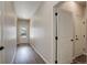 Inviting hallway featuring neutral walls, wood-look floors, and a front door letting in natural light at 8861 Ventura St, Commerce City, CO 80022